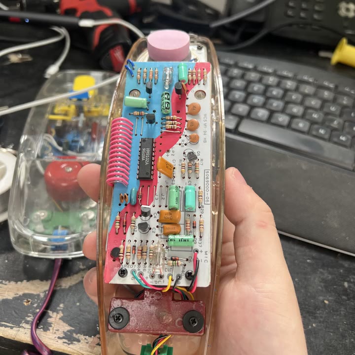 Transparent telephone handset with a circuit board and colored wiring visible inside