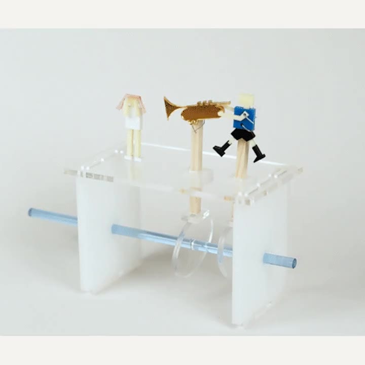 Acrylic automaton with a trumpet-playing figure and an exposed crank mechanism